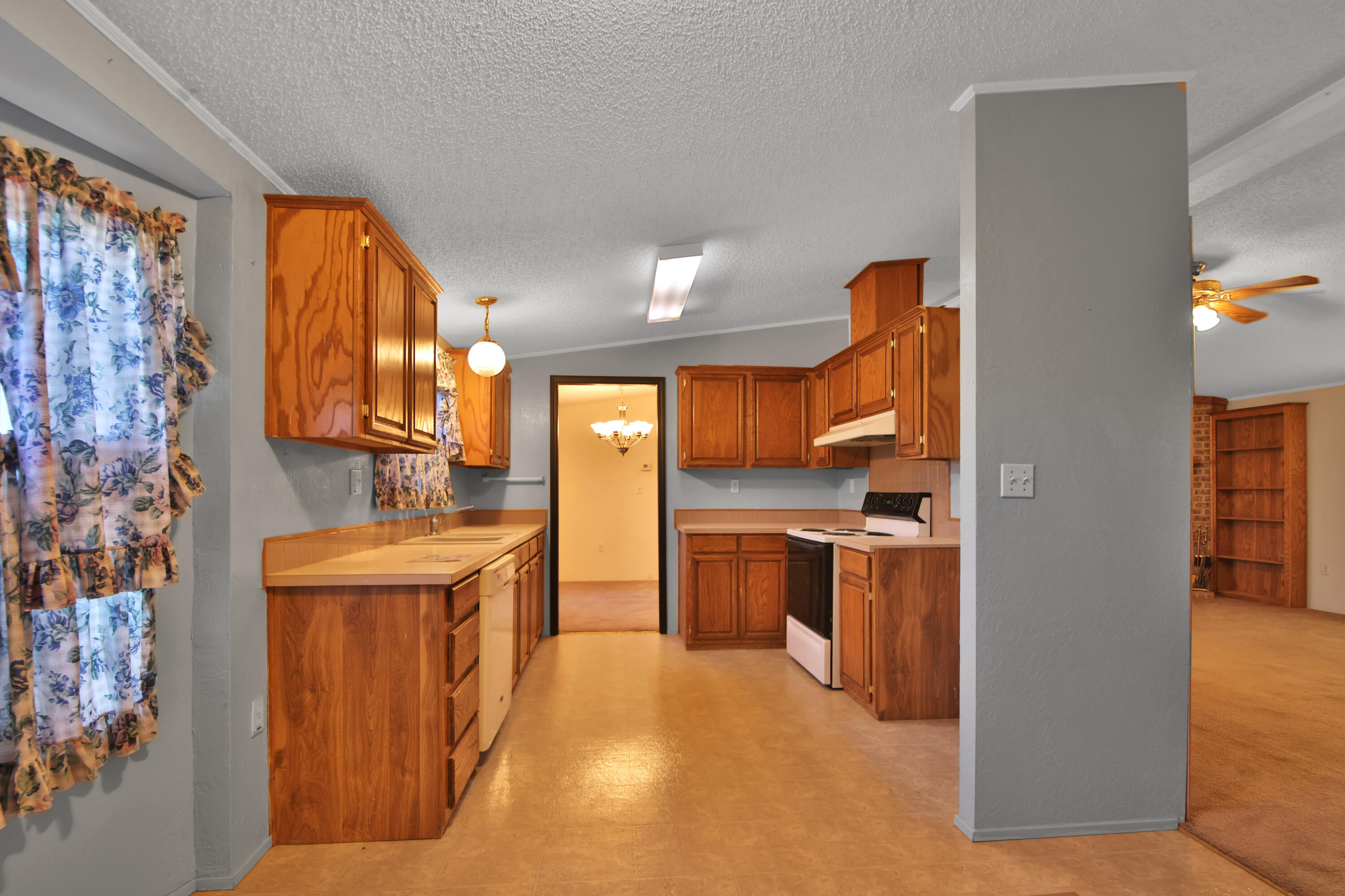 120 Highway 114 Estates Road Lubbock, TX 79407 - Photo 12 of 49 a kitchen with stainless steel appliances granite countertop a sink and a refrigerator