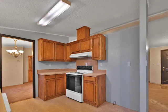 a kitchen with stainless steel appliances granite countertop a stove and a sink