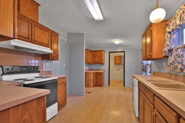 a kitchen that has a lot of cabinets in it