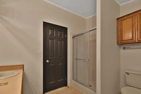 a bathroom with a sink a mirror and a shower