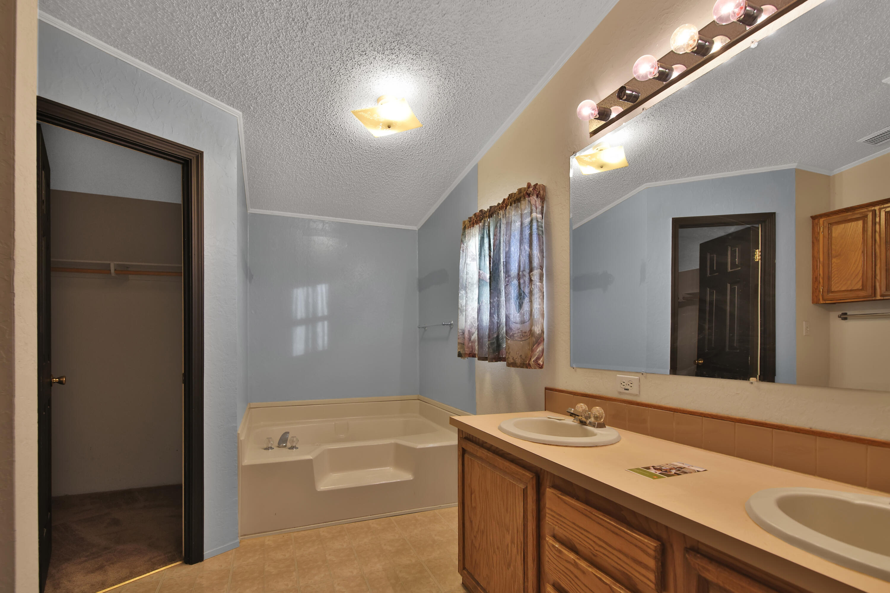 120 Highway 114 Estates Road Lubbock, TX 79407 - Photo 25 of 49 a bathroom with a sink a vanity and a mirror