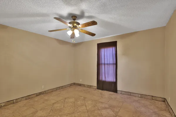 a view of a livingroom with a chandelier fan and a bathroom