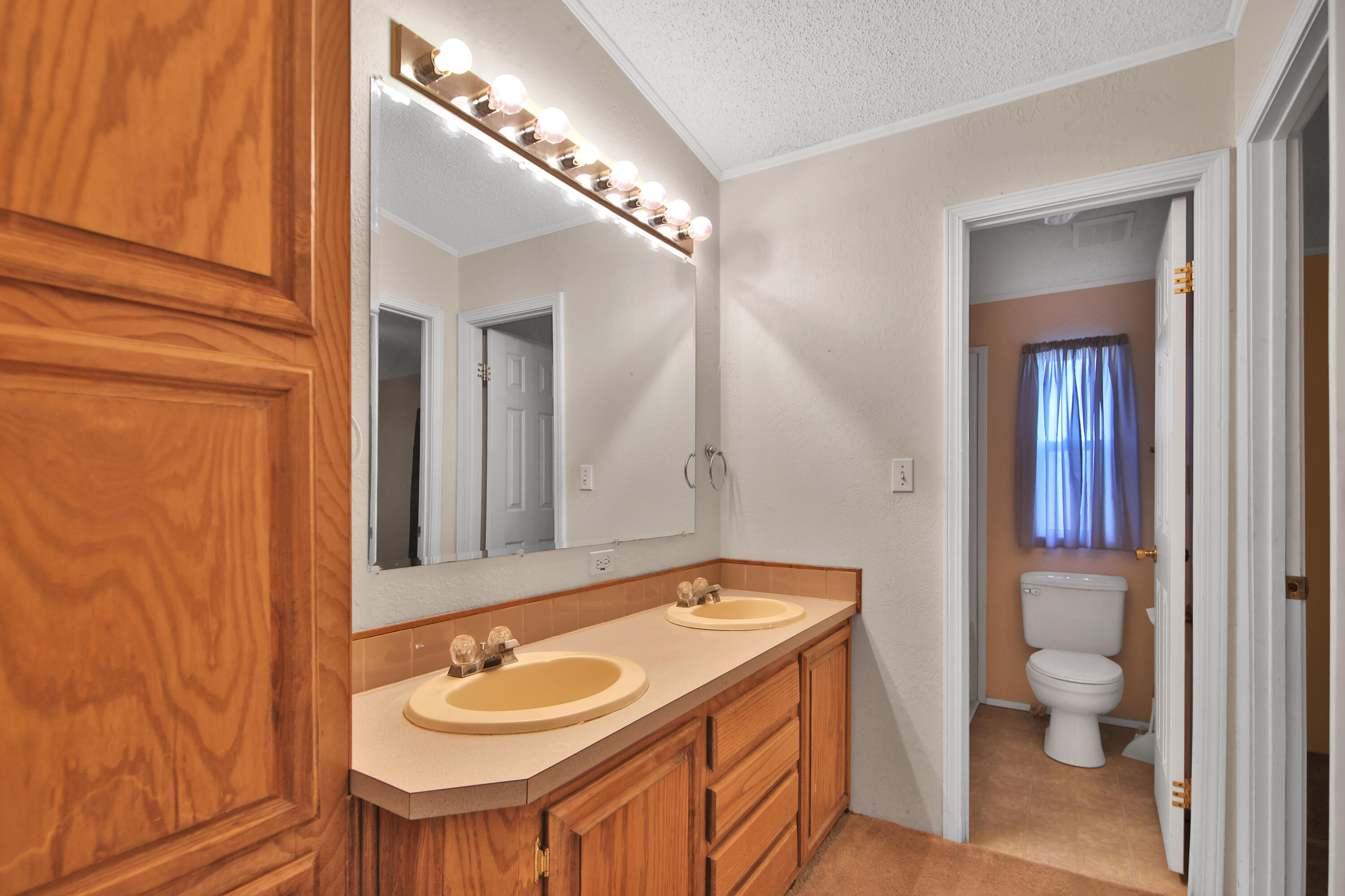 120 Highway 114 Estates Road Lubbock, TX 79407 - Photo 44 of 49 a bathroom with a granite countertop sink a toilet and mirror
