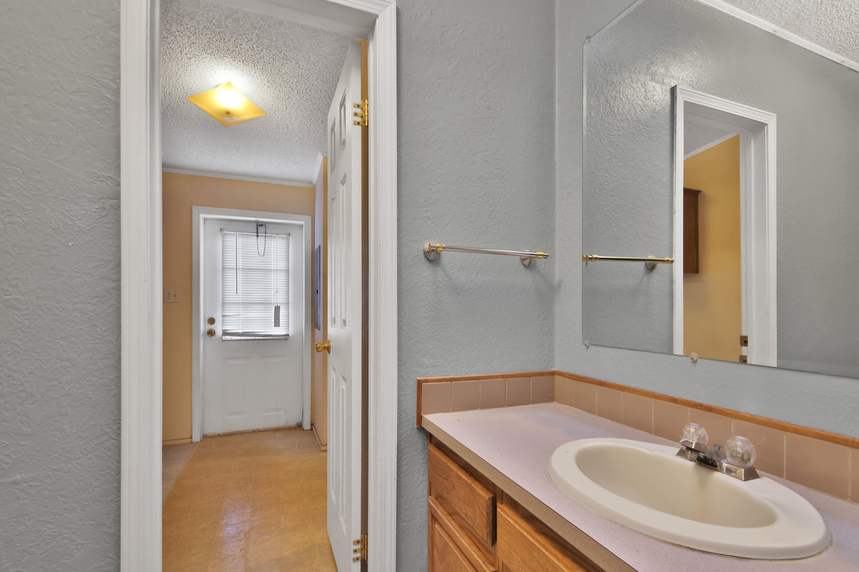 120 Highway 114 Estates Road Lubbock, TX 79407 - Photo 10 of 49 a bathroom with a sink and a mirror