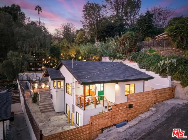 a view of a house with backyard and sitting area