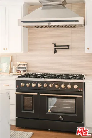 a open kitchen with stainless steel appliances granite countertop a stove and refrigerator
