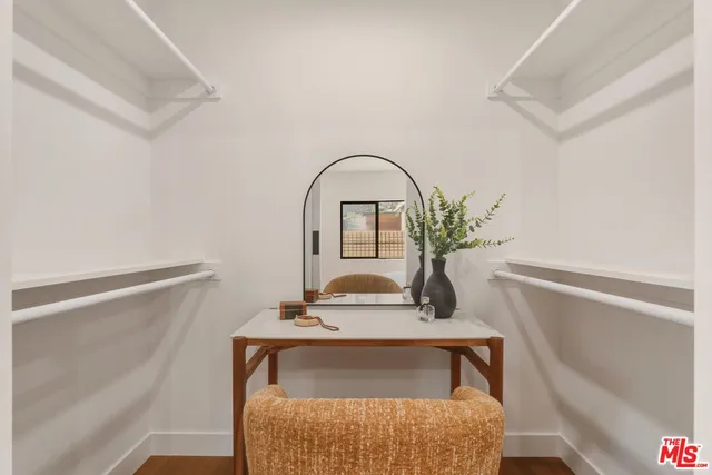 a bathroom with a tub a sink and glass door shower