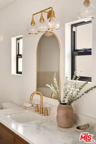 a living room with furniture a mirror and a table