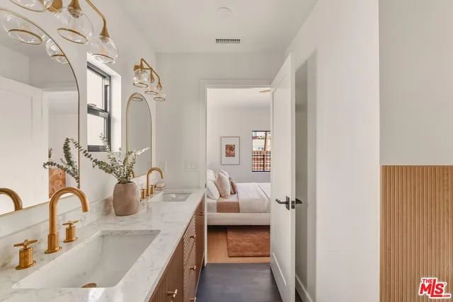 a bathroom with a sink and mirror with toilet