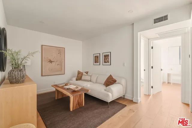 a bedroom with a bed and a painting on the wall