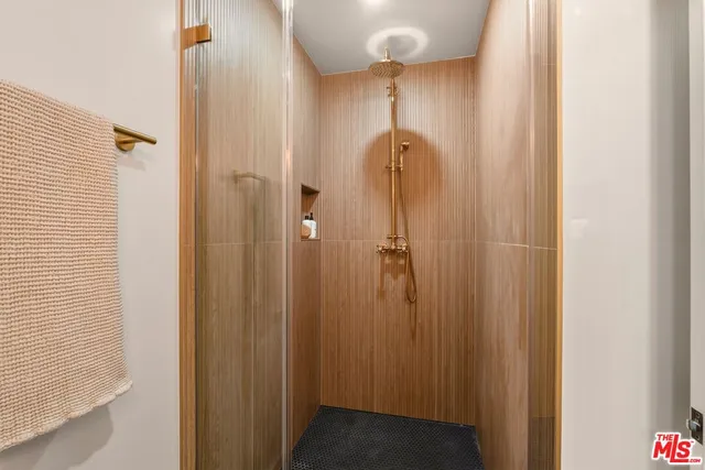 a view of a backyard with wooden floor and a large tree