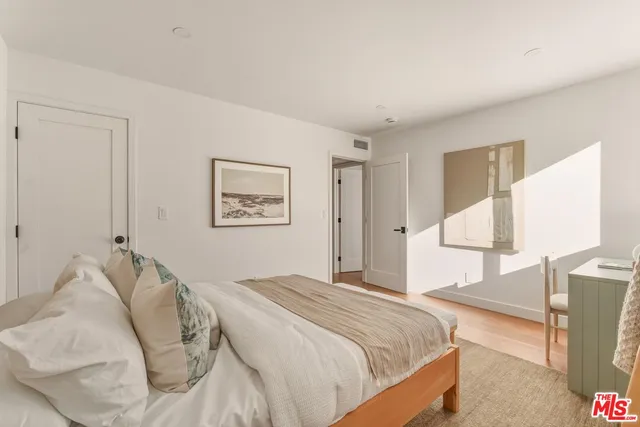 a roof deck with couches and wooden floor