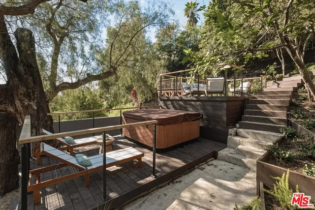 a view of backyard with a large tree