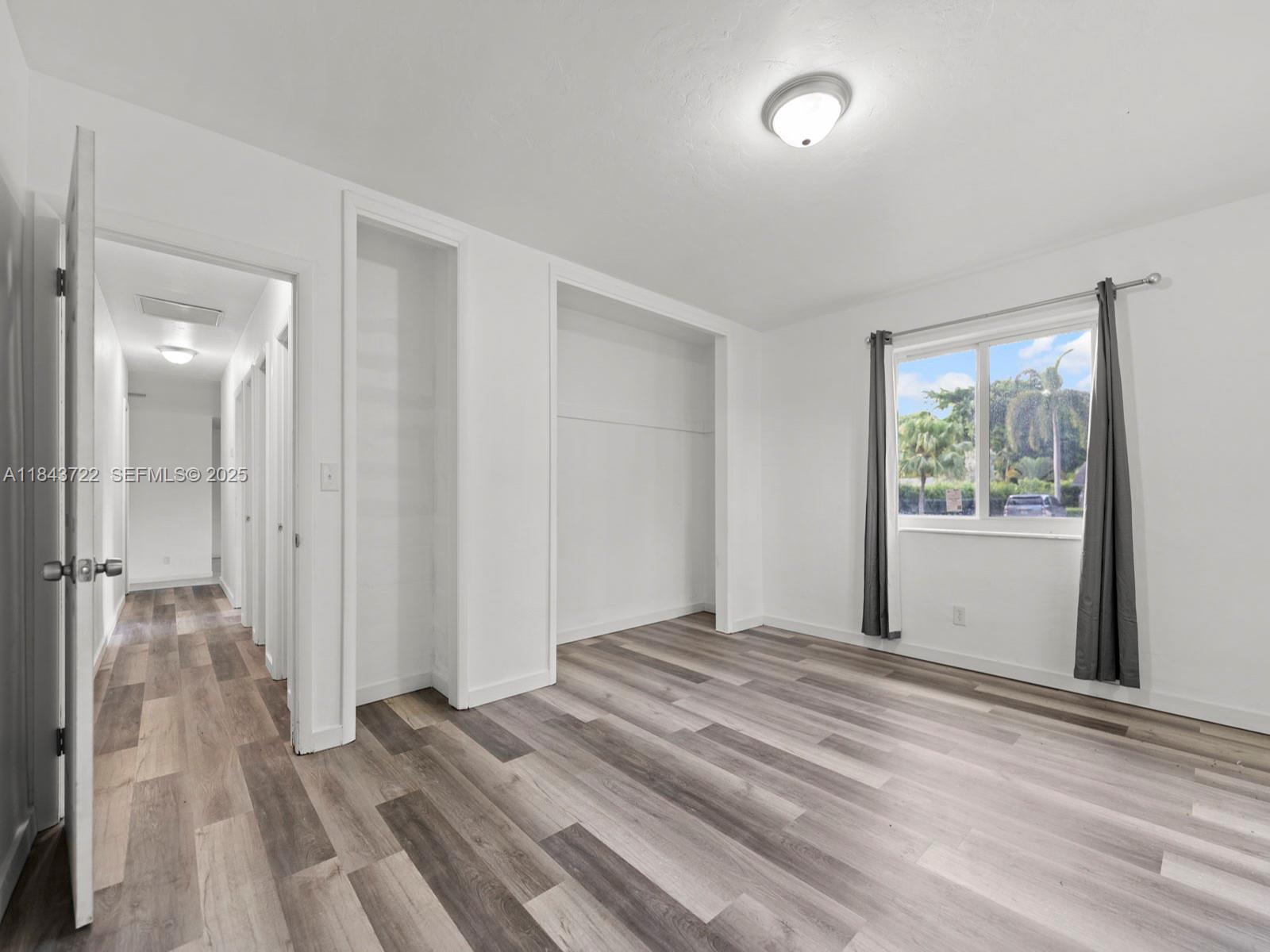 17300 Southwest 300th Street Homestead, FL 33030 - Photo 11 of 33 a view of a room with wooden floor and windows