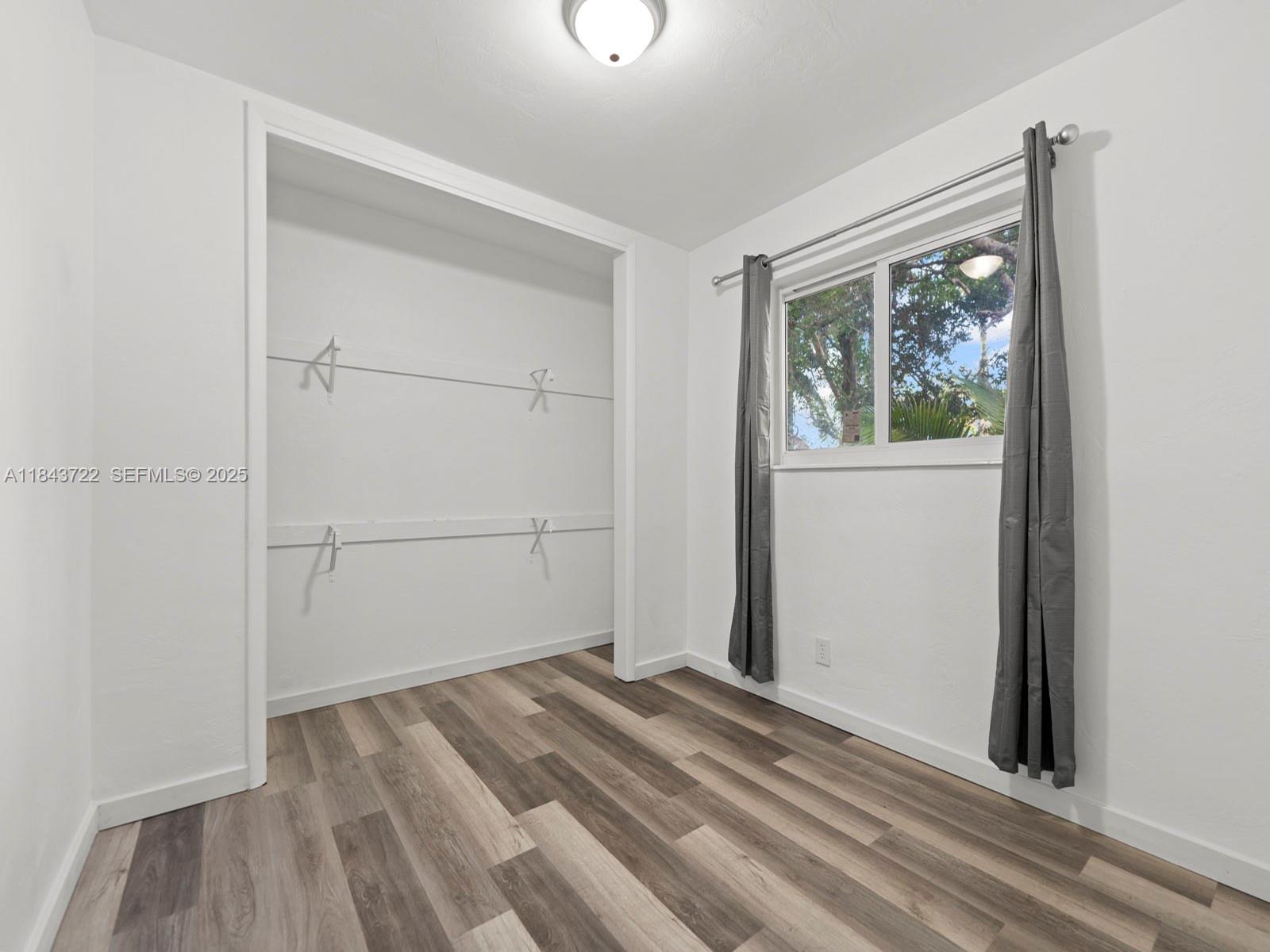 17300 Southwest 300th Street Homestead, FL 33030 - Photo 12 of 33 a view of a bedroom with wooden floor and natural light