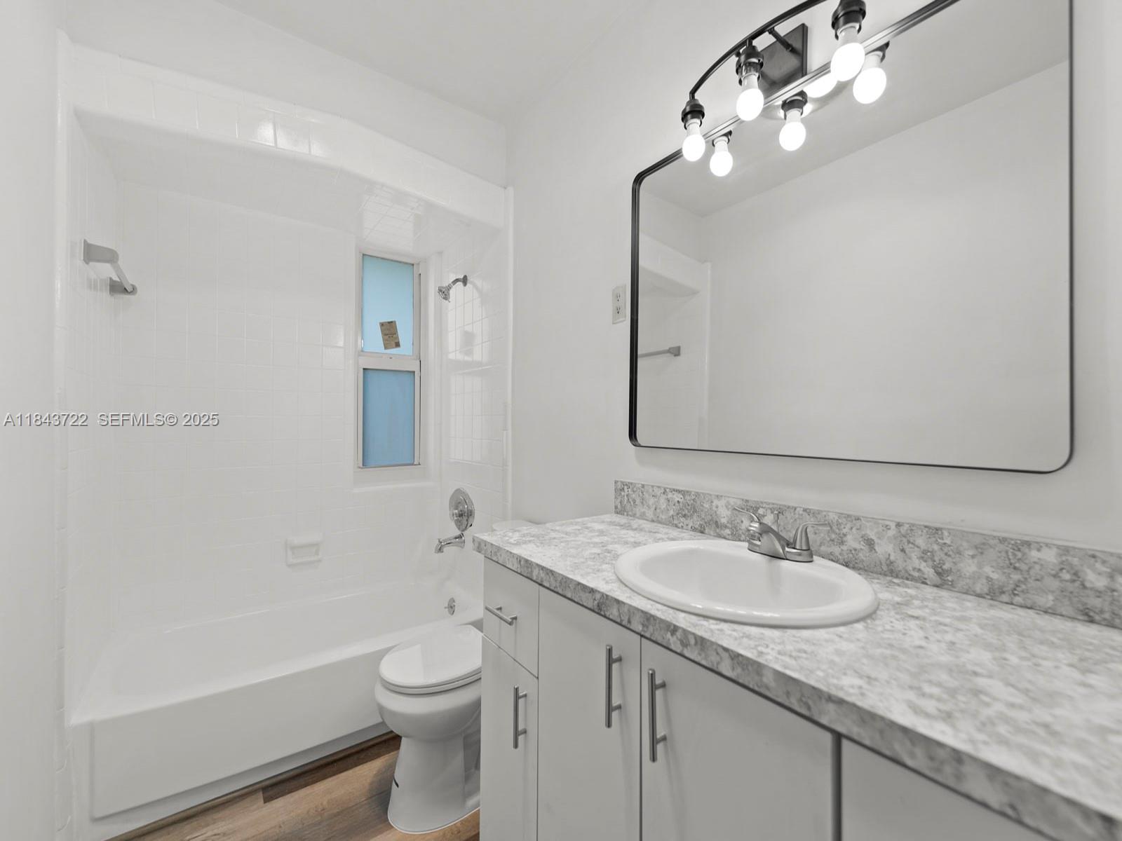17300 Southwest 300th Street Homestead, FL 33030 - Photo 15 of 33 a bathroom with a granite countertop sink a toilet and shower