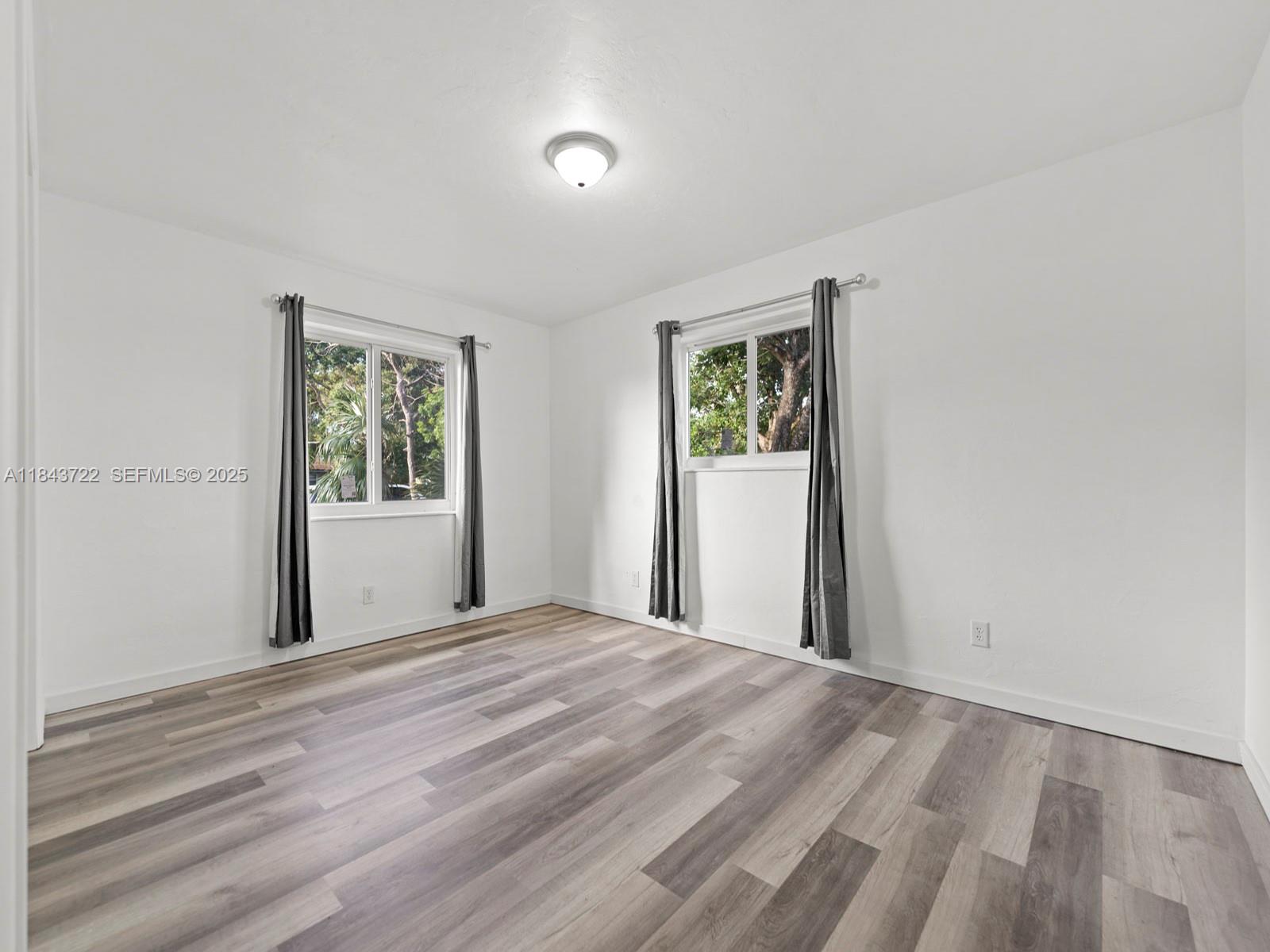 17300 Southwest 300th Street Homestead, FL 33030 - Photo 16 of 33 a view of a livingroom with wooden floor and a window