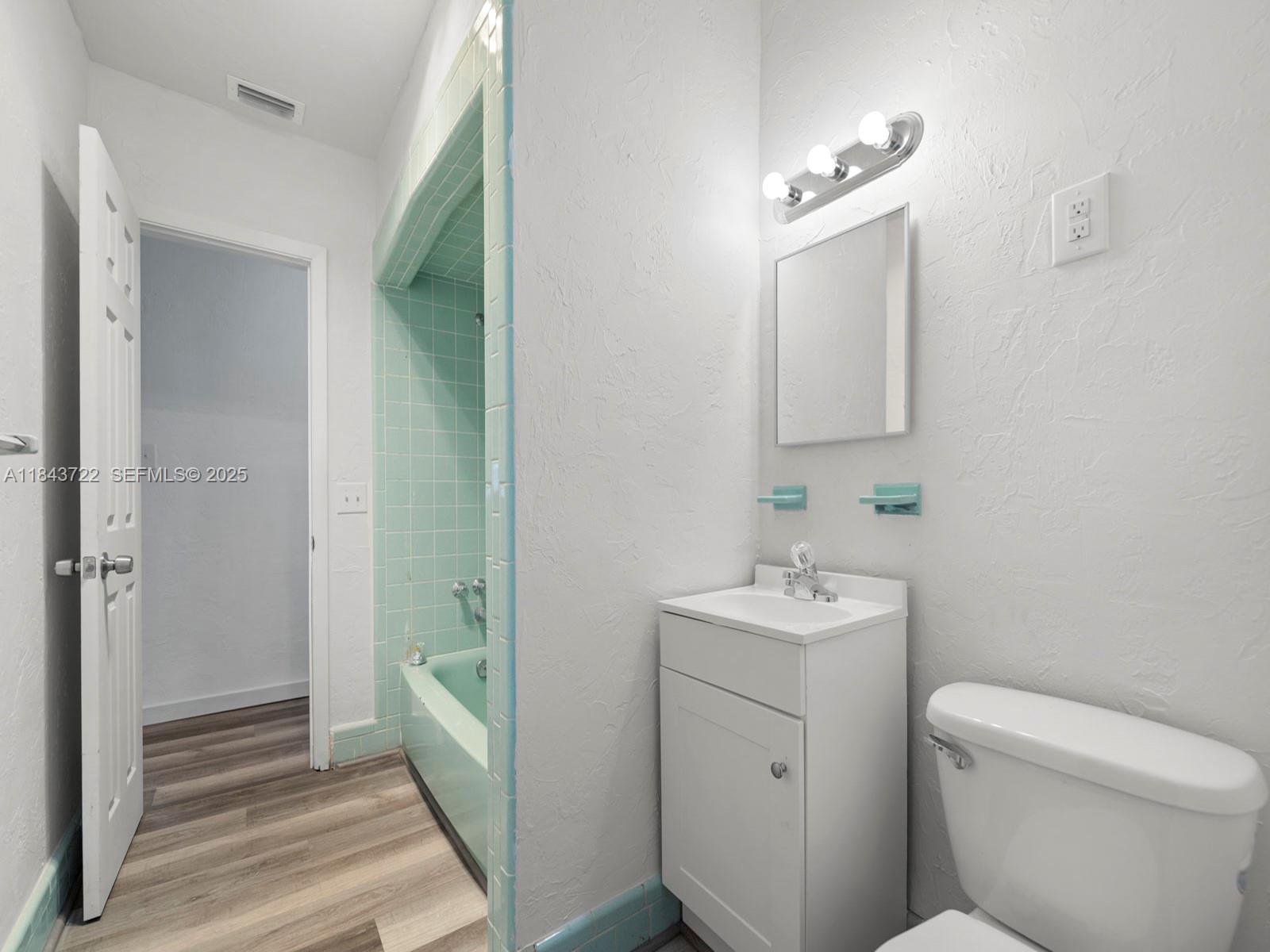 17300 Southwest 300th Street Homestead, FL 33030 - Photo 19 of 33 a bathroom with a toilet sink and mirror