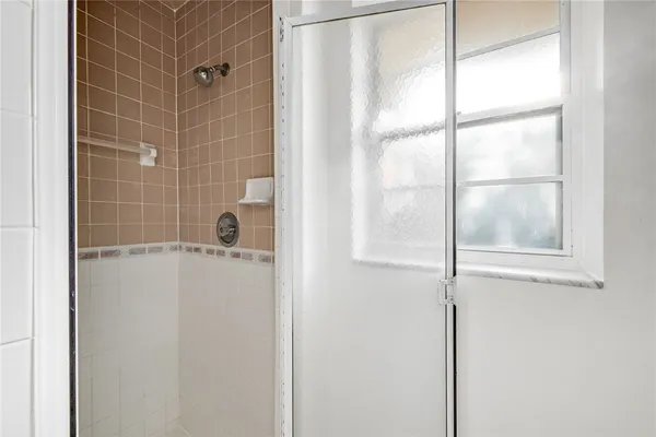 a bathroom with a bathtub a sink a vanity and a window