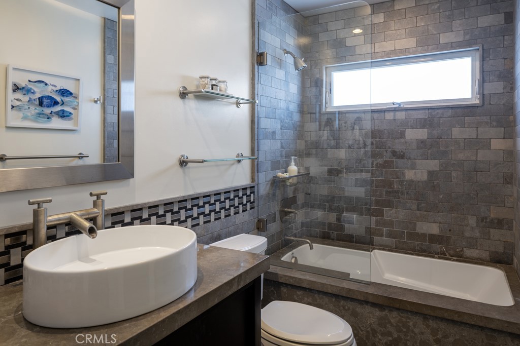 309 Marguerite Avenue, Unit C Corona del Mar, CA 92625 - Photo 11 of 15 a bathroom with a sink a toilet and bathtub