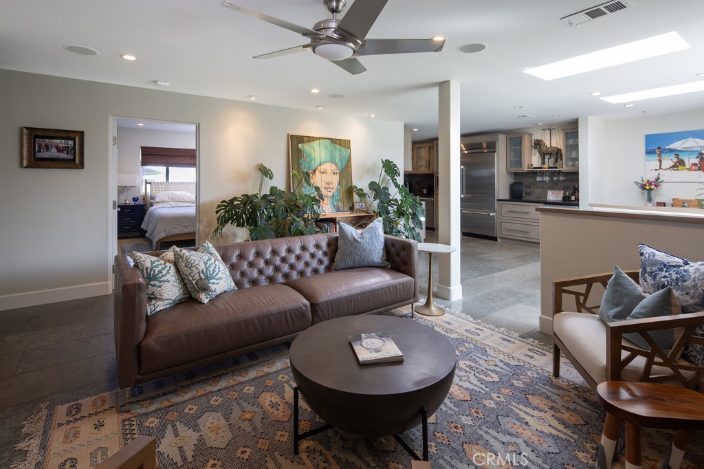 309 Marguerite Avenue, Unit C Corona del Mar, CA 92625 - Photo 3 of 15 a living room with furniture a rug and a chandelier