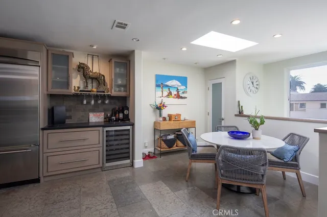 a kitchen with a dining table cabinets and appliances