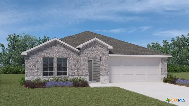 a view of a house with a small yard and a large tree