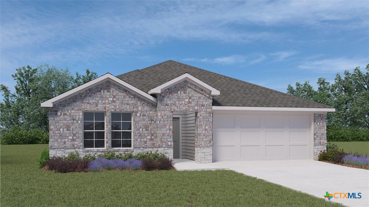 a view of a house with a small yard and a large tree