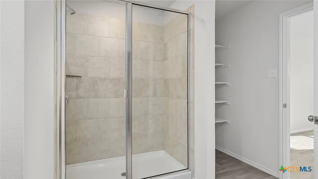a bathroom with a glass shower door