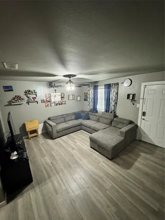 a bedroom with furniture and a wooden floor