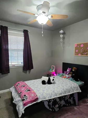 a bedroom with a bed dresser and a window