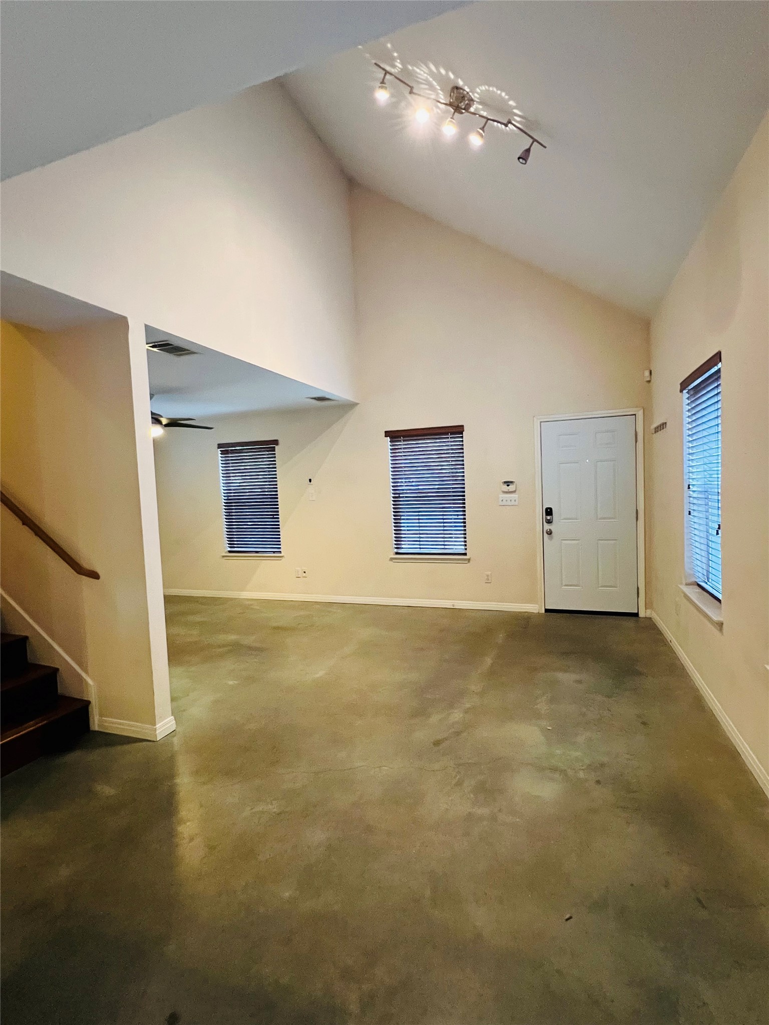 2409 Santa Rosa Street Austin, TX 78702 - Photo 9 of 27 Soaring vaulted ceilings and polished concrete floors create an airy, modern entryway.