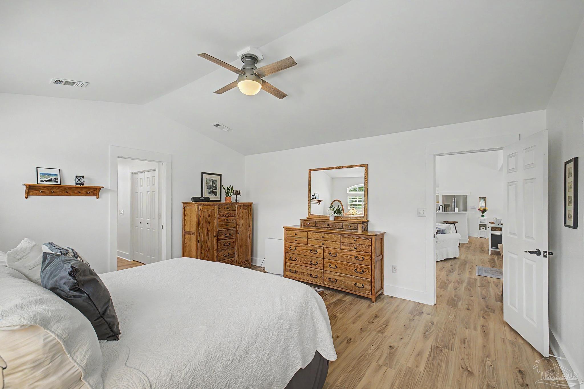 2005 Riviera Lane South Navarre, FL 32566 - Photo 22 of 70 a bedroom with a bed and wooden floor