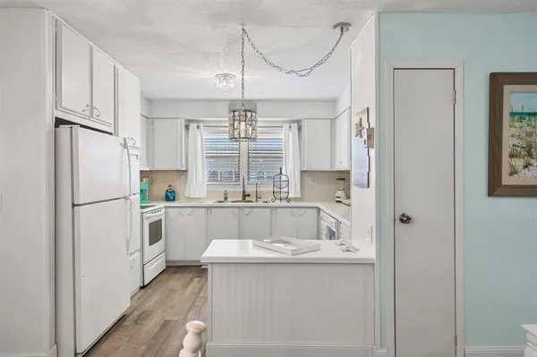 a kitchen with refrigerator a sink and cabinets