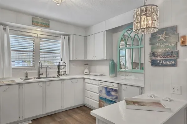 a kitchen with a sink cabinets and window