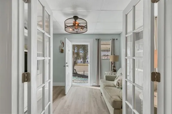 a view of a hallway with a livingroom and a dinning room with balcony
