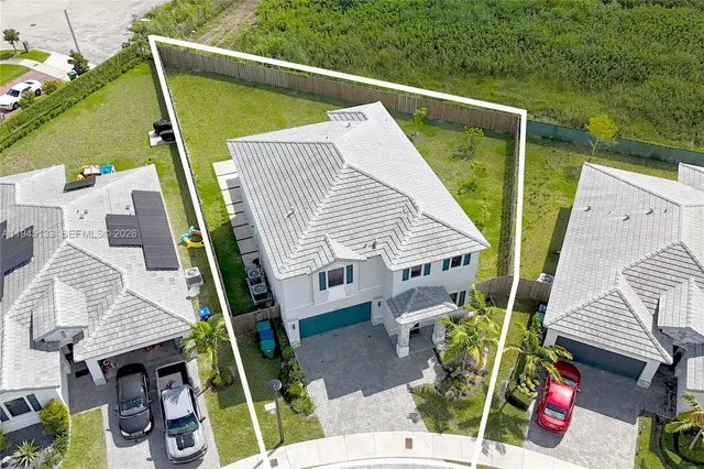an aerial view of residential houses with outdoor space