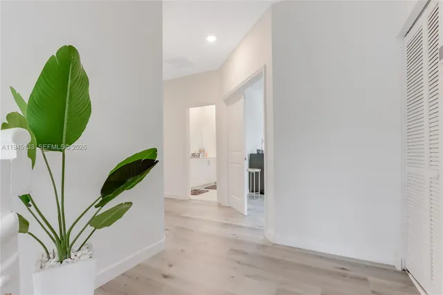 a spacious bedroom with a bed couch and a window