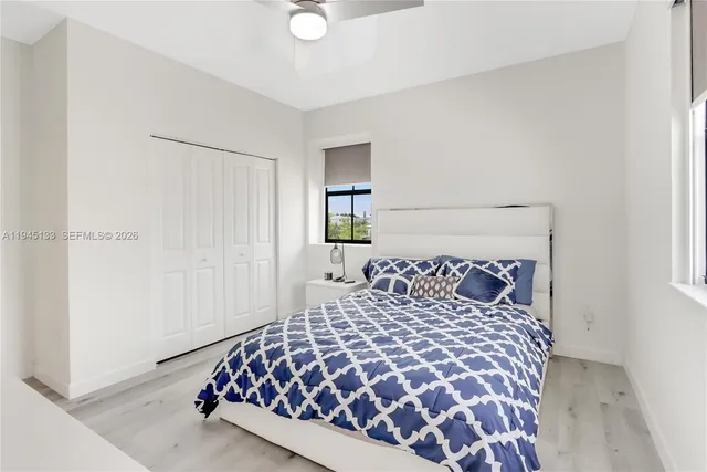 a bedroom with a bed and a baby crib