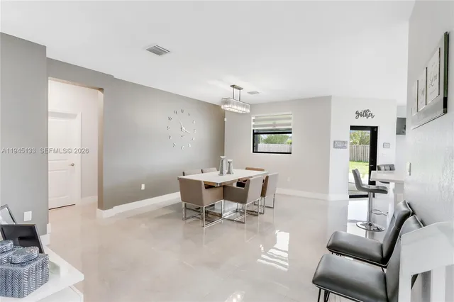 a view of kitchen with refrigerator and microwave