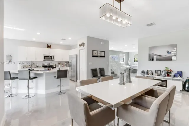 a kitchen with stainless steel appliances kitchen island granite countertop a sink and cabinets