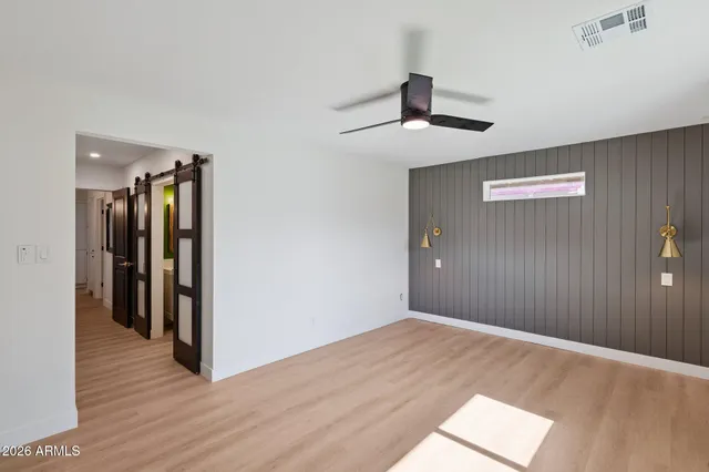 a view of an empty room with wooden floor