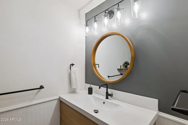 a bathroom with a sink and a mirror