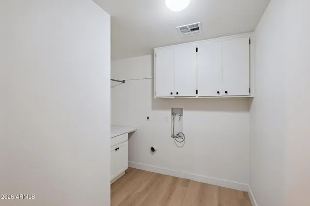 a view of storage and utility room with a window