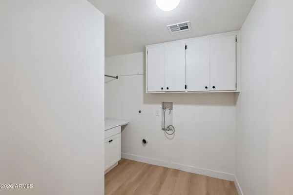 a view of storage and utility room with a window