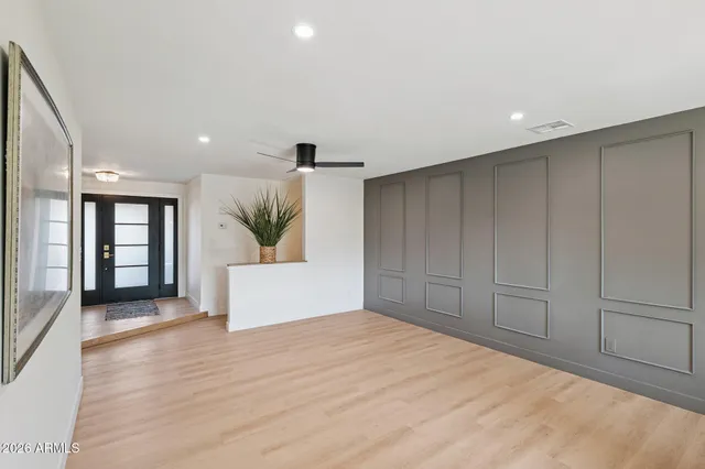 a living room with furniture and wooden floor