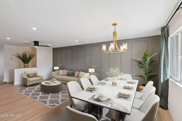 a living room with furniture a window and a dining table