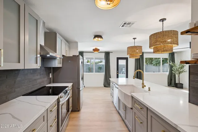 a kitchen with stainless steel appliances a sink stove and refrigerator