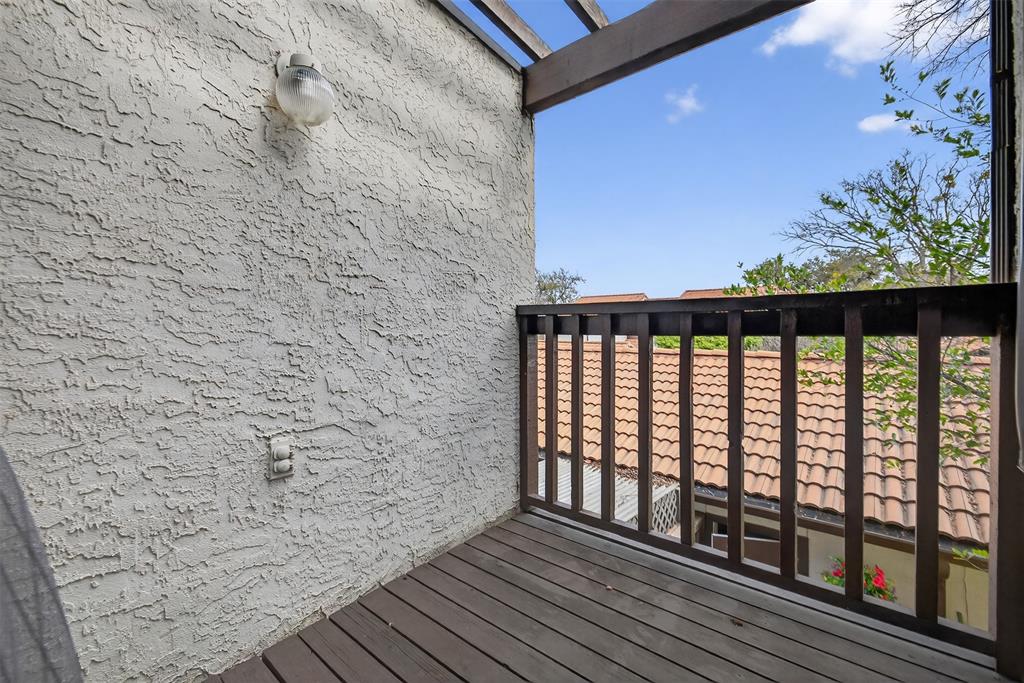 18040 Midway Road, Unit 195 Dallas, TX 75287 - Photo 16 of 17 a view of a balcony with wooden floor