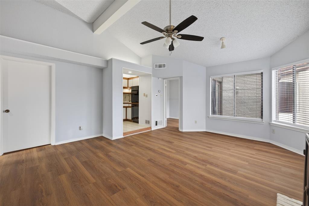 18040 Midway Road, Unit 195 Dallas, TX 75287 - Photo 5 of 17 a view of empty room with wooden floor and fan